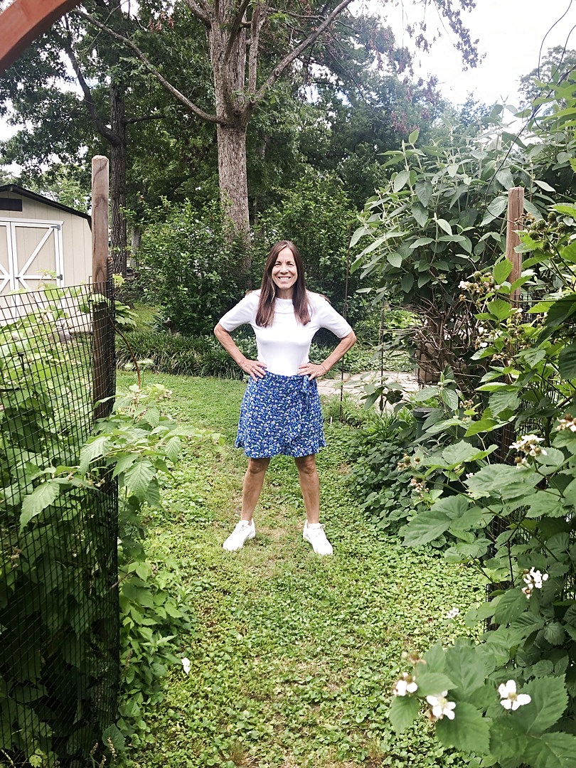 Maggie Clark Castor in her garden with hydrangeas